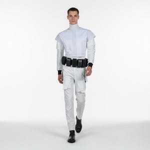 May include: A futuristic outfit in white and black. The ensemble features a high-collared top with vertical lines, white cargo pants, and a black belt with pouches. The outfit is completed with black boots.