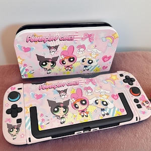 May include: A pink Nintendo Switch case and controller, both decorated with a Powerpuff Girls theme. The design includes cartoon characters, rainbows, and hearts. The case is rectangular, and the controller has black buttons. The words "Powerpuff Girls" are in pink.