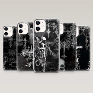 May include: A selection of black and white phone cases with gothic and fantasy imagery. The cases showcase illustrations of angels, crosses, and script. The cases are made of clear plastic, allowing the phone's colour to show through.