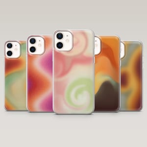 May include: Five phone cases with abstract, blended designs in shades of orange, pink, green, and brown. Each case has a clear border and a camera cutout. The swirling patterns create a unique, artistic look for the phone.