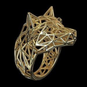 May include: A gold-colored ring featuring a geometric wolf head design. The wolf's head is crafted from interconnected triangular shapes, creating a three-dimensional effect. The ring is set against a black background.