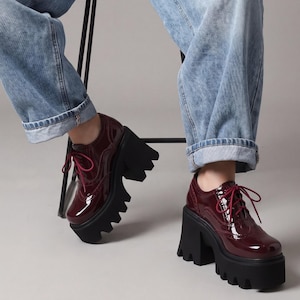 Patent leather platform pumps chunky block heel lace-up closure deep lug sole women statement footwear gothic party heels ankle height reinforced eyelet construction cushioned insole