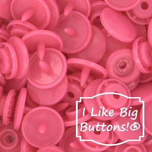 May include: A close-up of a pile of pink plastic snap buttons. The buttons are all the same size and shape, and they have a small, raised bump in the center. The buttons are arranged in a random pattern, and they are all in focus.