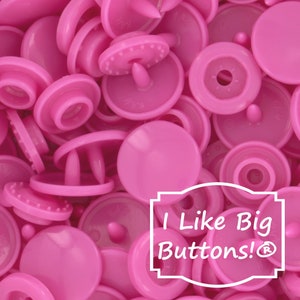 May include: A large pile of pink plastic snap buttons. The buttons are all the same size and shape, and they are arranged in a random pattern. The text "I Like Big Buttons!®" is superimposed on the image.
