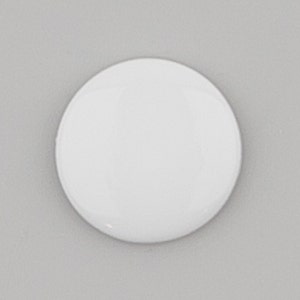 May include: A blank white round button, perfect for crafting or adding a personal touch to projects.