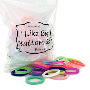May include: A clear plastic bag filled with a random mix of colorful, large silicone rings. The bag has the text "I Like Big Buttons!" and "Pieces" printed on it. Several rings are scattered in front of the bag, in shades of blue, green, pink, purple, and orange.