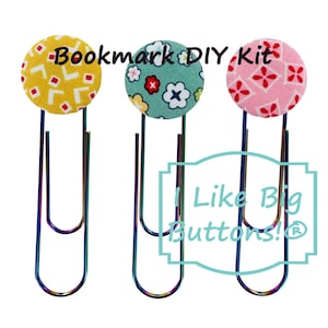 May include: Three colorful bookmark DIY kits. Each kit features a large, patterned button attached to a rainbow-colored paper clip. The buttons have yellow, green, and pink backgrounds with floral designs. Text on the image reads "Bookmark DIY Kit" and "I Like Big Buttons!"