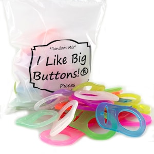 May include: A clear plastic bag filled with colorful, translucent buttons. The buttons are in various shapes and colors, including pink, green, blue, and purple. The bag has a label that reads "I Like Big Buttons!" in black text.