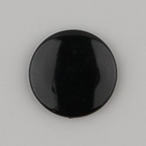 May include: A black round button with a glossy finish.