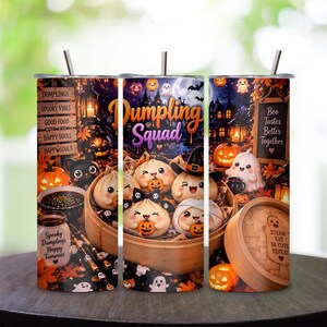 May include: Three cylindrical tumblers with metal straws featuring a Halloween-themed design. The graphics include cartoon dumplings, ghosts, pumpkins, and black cats. Text includes "Dumpling Squad," "Spooky Vibes," "Boo Tastes Better Together," and "Steam Eat Be Cute Repeat."