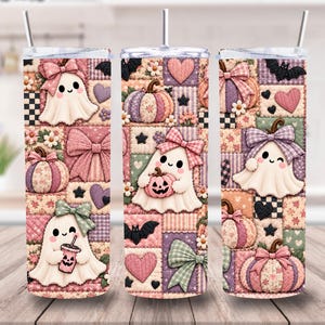 May include: Three cylindrical tumblers with clear lids and straws, featuring a repeating patchwork pattern of white ghosts, pink and purple pumpkins, bows, hearts, stars, and black bats on a quilted background in shades of pink, purple, and green.