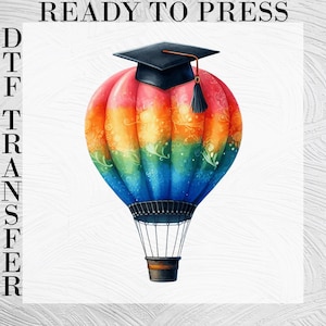 May include: A colorful hot air balloon with a rainbow gradient pattern featuring red, orange, yellow, green, and blue hues, topped with a black graduation cap and tassel. The text READY TO PRESS DTF TRANSFER is visible on the sides.