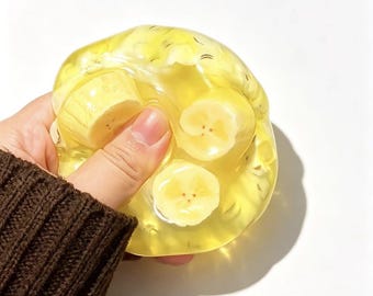 Banana Jelly Taba Squishy | Clear Fruit Slice Fidget Toy | Ultra Soft Water Jelly Squeeze | Realistic Fake Food | ASMR Tactile Desk Pet