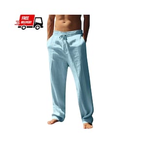 Puede incluir: Pantalones de lino azul claro con cintura con cordón y bolsillos. Los pantalones son de color liso y parecen ligeros. La imagen también incluye un gráfico de un camión de reparto con las palabras "FREE DELIVERY".