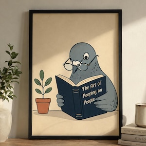 May include: A framed wall art print featuring a grey pigeon wearing round glasses and reading a dark blue book titled The Art of Pooping on People. Next to the pigeon is a small green potted plant in a terracotta pot on a beige background.