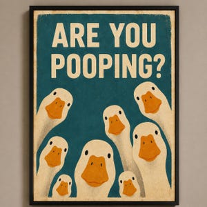 May include: A framed wall art print featuring a dark teal background with the text ARE YOU POOPING? in large cream-colored letters. Below the text, seven white geese with orange beaks are depicted looking upward toward the viewer.