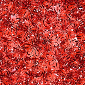 May include: A close-up of a red and white patterned glass flower design. The glass flowers are translucent and have a shiny finish.