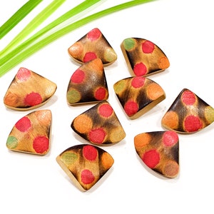 Pode incluir: Dez botões de madeira em forma triangular com fundo laranja queimado e bolinhas vermelhas, laranja e verdes.