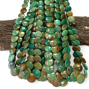 May include: A collection of round, flat turquoise beads arranged in multiple vertical strands. Each bead displays a unique blend of vibrant teal, green, and earthy brown matrix patterns, creating a varied, natural appearance across the entire set.