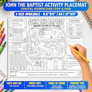 Op de afbeelding: Een zwart-wit placemat met activiteiten over Johannes de Doper, voorzien van een centrale illustratie van een bijbelse scène, een doolhof, woordzoekers en diverse educatieve spellen. De tekst bevat John the Baptist, Prepare the Way of the Lord.