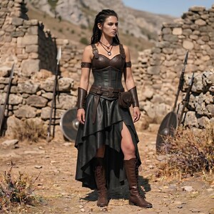 May include: A dark brown leather corset top with matching arm guards and a black high-low skirt. The outfit includes a leather belt with a small attached pouch and brown lace-up boots. The ensemble features metallic buckles and dark leather straps.