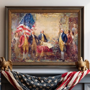 May include: A framed print depicting the signing of the United States Constitution with historical figures, an American flag, and the text We the People. Below, a draped American flag, two golden eagle figurines, and a tall brown candle stand.