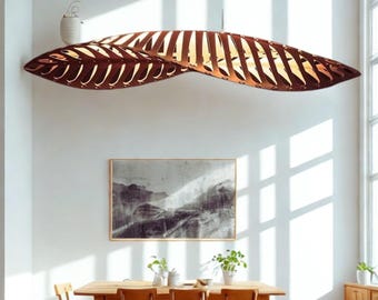 Puede incluir: Una gran lámpara colgante en forma de hoja, de color marrón, cuelga sobre una mesa de comedor de madera. La luz tiene una serie de secciones recortadas que permiten que la luz se filtre. El comedor cuenta con una gran ventana y una pintura de paisaje.