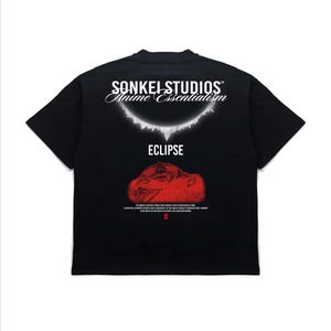 May include: Black t-shirt with the text "SONKEI STUDIOS Anime Essentialism" above the word "ECLIPSE". A red graphic is below the word "ECLIPSE". The shirt has short sleeves and a crew neck.