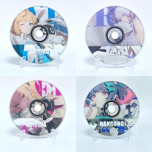 May include: Four circular discs featuring anime-style character illustrations. The top left disc shows a blonde character labeled NORMA. The top right disc shows a character labeled VELINA. The bottom left is labeled CISSIA, and the bottom right is NANGONG YU.
