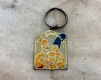 The Simpsons -- Vintage enamel keychain depicting yellow cartoon people -- Made in Taiwan