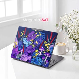 May include: A laptop skin featuring a vibrant botanical pattern with purple and blue monstera leaves, yellow wildflowers, red spikes, and purple mushrooms on a dark blue background. The text Magnolia SAT is printed above the laptop.