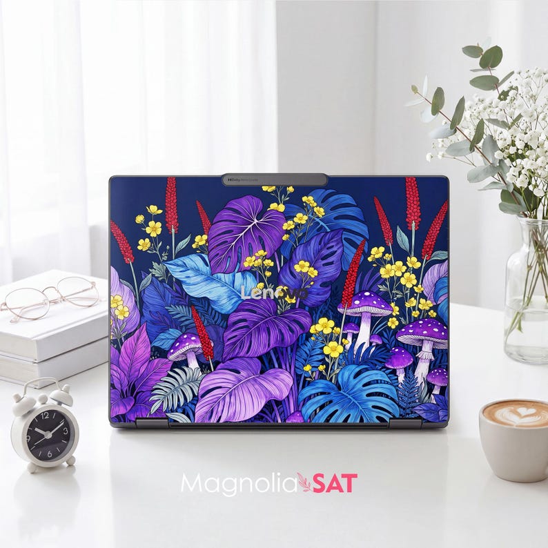 May include: A laptop skin featuring a vibrant botanical pattern with purple and blue monstera leaves, yellow wildflowers, red vertical floral spikes, and purple mushrooms against a dark blue background. The Lenovo logo is visible in the center.