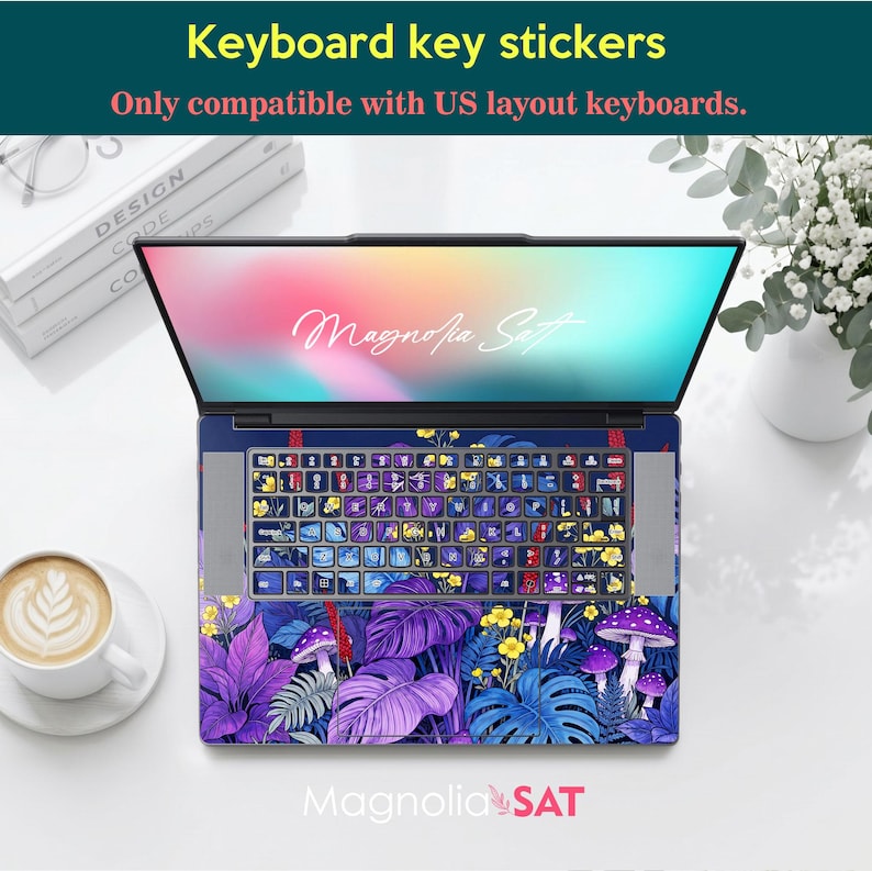 May include: A laptop featuring a keyboard skin and palm rest decal with a vibrant botanical pattern of purple and blue leaves, yellow flowers, and mushrooms. The screen displays the text Magnolia Sat. The stickers are for US layout keyboards.