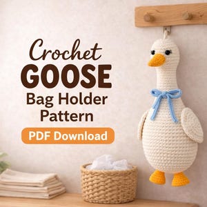 May include: A crocheted goose bag holder, cream-colored with a blue bow, orange beak and feet, hangs on a wooden rack. The text "Crochet GOOSE Bag Holder Pattern PDF Download" is displayed in the image. A wicker basket and folded towels are in the foreground.