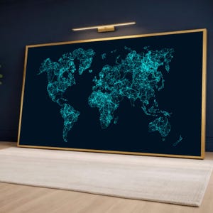 May include: A large framed world map art print. The map is a network of teal lines and dots against a dark blue background. The frame is gold. The artwork is displayed on a wall above a light-colored rug.
