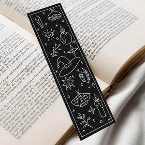 May include: A white ceramic mug with a black handle and the text "But First, Coffee" in a bold, black font. The mug is set against a blurred background, suggesting a cozy setting. The mug appears to be approximately 4 inches tall.