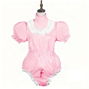 May include: A pink romper with a high collar and short, puffy sleeves. The romper features white ruffled trim around the collar and leg openings. The garment has a gathered waist and a decorative opening in the front.