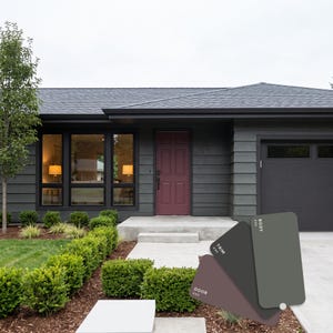 May include: A single-story house with dark gray horizontal siding, a dark gray roof, and a maroon front door. A color palette card is displayed in the foreground, showing three rectangular swatches labeled BODY, TRIM, and DOOR in matching colors.