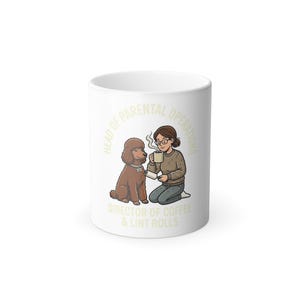 May include: White ceramic mug with a cartoon illustration of a brown poodle and a person holding a coffee cup. The mug has the text "HEAD OF PARENTAL OPERATIONS" and "DIRECTOR OF COFFEE & LINT ROLLS" in a light green color.