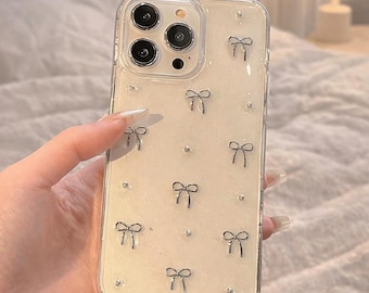 Funda para iPhone con lazo brillante estilo coreano, cubierta de TPU suave de epoxi transparente.