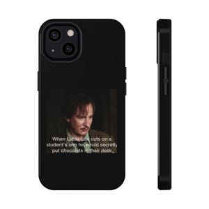 May include: Black phone case featuring a quote from a movie. The quote reads, "When Lupin saw cuts on a student's arm he would secretly put chocolate in their desk." The case has a glossy finish and a camera cutout.