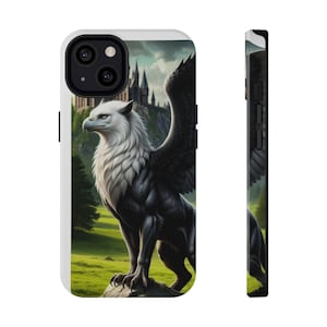 May include: A white and black phone case featuring a griffin illustration. The griffin is depicted with a white head and chest, black body and wings, and is set against a backdrop of a castle and green landscape. The case is white with black accents.