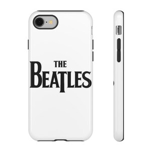 May include: White phone case with the band name "The Beatles" in black, bold lettering. The case has a black border and a camera cutout. The side view shows the case's slim profile and black buttons.