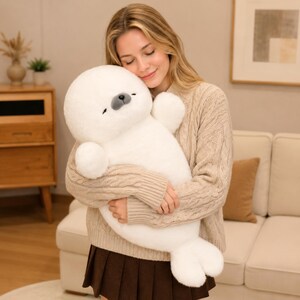 Kawaii sleeping seal plush with soft white plush fabric and PP cotton filling, cute seal pillow for kids and adults, large 70cm size perfect for cuddling and home decor, calming plush toy for bedrooms, sofas, and living room styling, adorable animal plushie for a cozy touch in any room, comforting seal stuffed animal for relaxation and stress relief, perfect gift for children and seal lovers, cute addition to any home decor collection