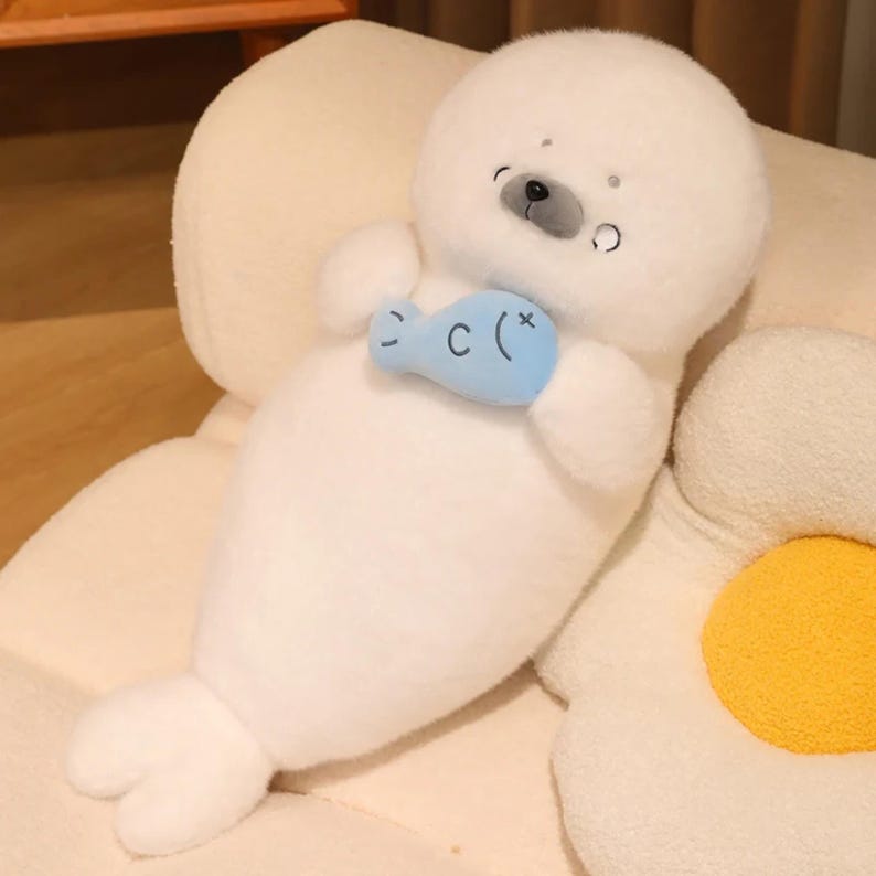 Kawaii sleeping seal plush with soft white plush fabric and PP cotton filling, cute seal pillow for kids and adults, large 70cm size perfect for cuddling and home decor, calming plush toy for bedrooms, sofas, and living room styling, adorable animal plushie for a cozy touch in any room, comforting seal stuffed animal for relaxation and stress relief, perfect gift for children and seal lovers, cute addition to any home decor collection