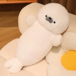 Kawaii sleeping seal plush with soft white plush fabric and PP cotton filling, cute seal pillow for kids and adults, large 70cm size perfect for cuddling and home decor, calming plush toy for bedrooms, sofas, and living room styling, adorable animal plushie for a cozy touch in any room, comforting seal stuffed animal for relaxation and stress relief, perfect gift for children and seal lovers, cute addition to any home decor collection