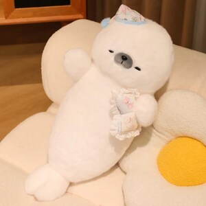 Kawaii sleeping seal plush with soft white plush fabric and PP cotton filling, cute seal pillow for kids and adults, large 70cm size perfect for cuddling and home decor, calming plush toy for bedrooms, sofas, and living room styling, adorable animal plushie for a cozy touch in any room, comforting seal stuffed animal for relaxation and stress relief, perfect gift for children and seal lovers, cute addition to any home decor collection