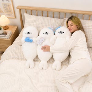 Kawaii sleeping seal plush with soft white plush fabric and PP cotton filling, cute seal pillow for kids and adults, large 70cm size perfect for cuddling and home decor, calming plush toy for bedrooms, sofas, and living room styling, adorable animal plushie for a cozy touch in any room, comforting seal stuffed animal for relaxation and stress relief, perfect gift for children and seal lovers, cute addition to any home decor collection