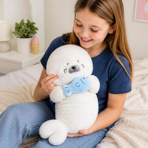 Kawaii sleeping seal plush with soft white plush fabric and PP cotton filling, cute seal pillow for kids and adults, large 70cm size perfect for cuddling and home decor, calming plush toy for bedrooms, sofas, and living room styling, adorable animal plushie for a cozy touch in any room, comforting seal stuffed animal for relaxation and stress relief, perfect gift for children and seal lovers, cute addition to any home decor collection