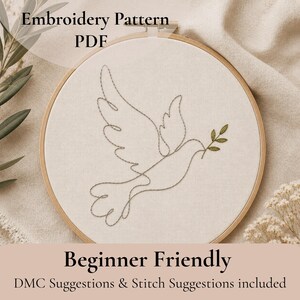 May include: A circular wooden embroidery hoop containing off-white fabric with a minimalist grey outline of a dove in flight holding a small green olive branch. The text Embroidery Pattern PDF and Beginner Friendly DMC Suggestions & Stitch Suggestions included is visible.